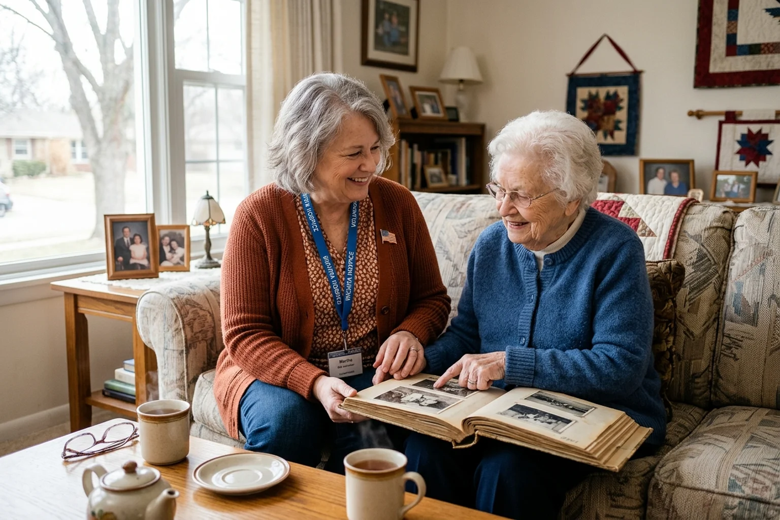 Hospice volunteer and senior woman smiling warmly together during a friendly home visit in Wichita